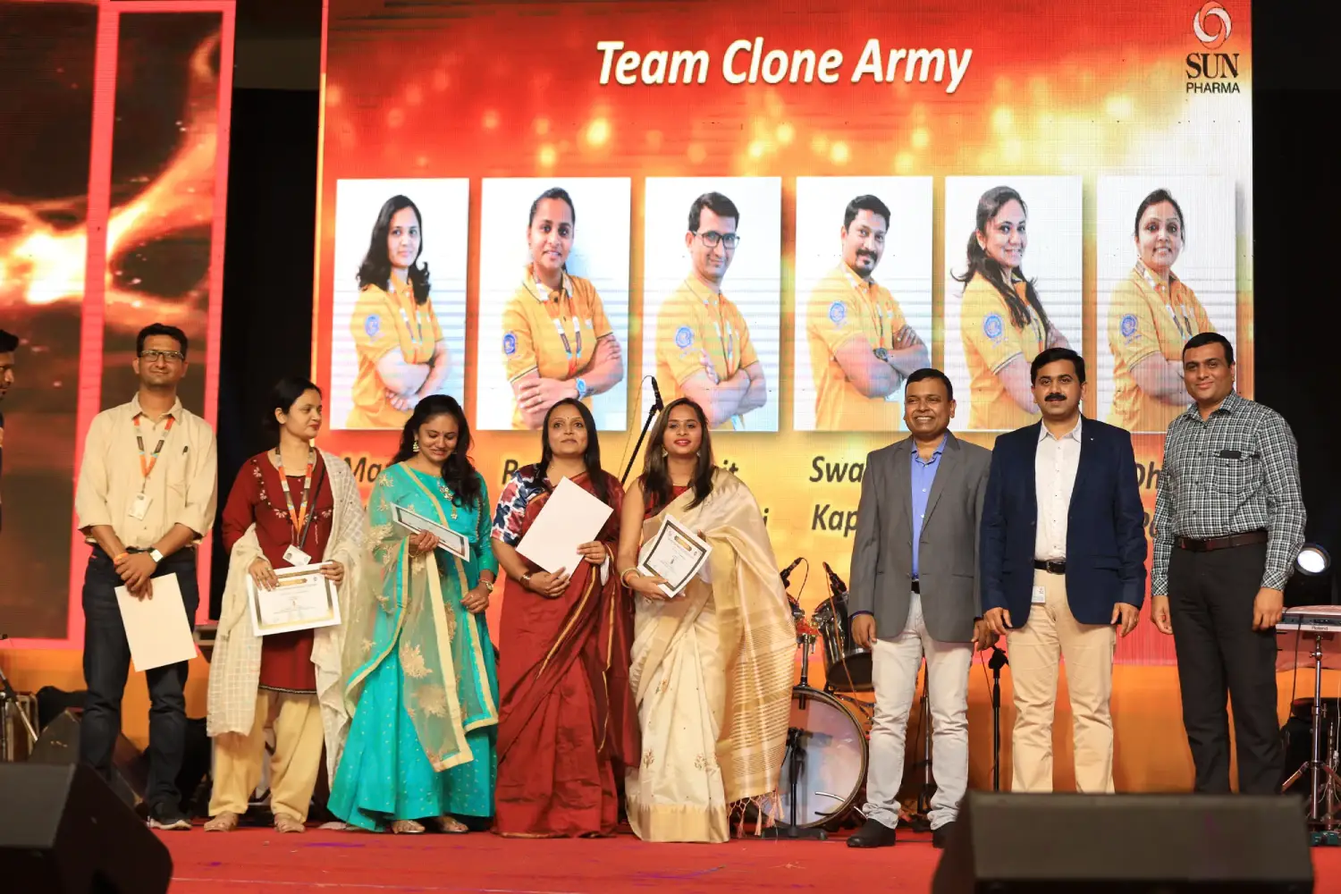 Men lighting ceremonial lamp at event with ITT banner in background